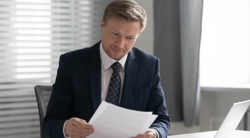Business executive reading CAPE denial letter
