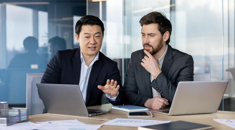 Two male internal auditors discussing standards