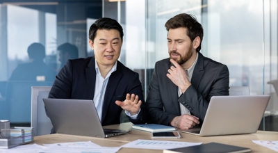 Two male internal auditors discussing standards