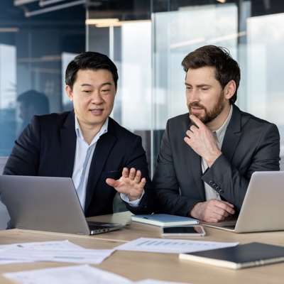 Two male internal auditors discussing standards