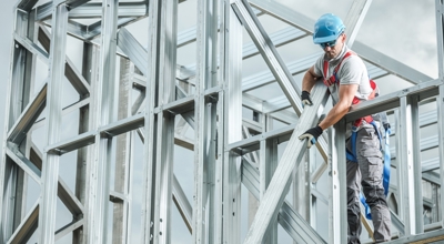 Construction manager handling steel beams