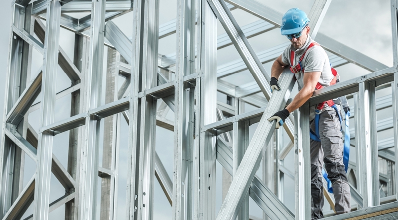Construction manager handling steel beams