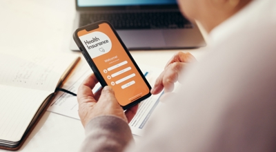 Staffing professional viewing health insurance on cellphone