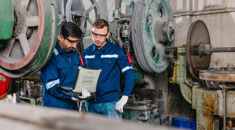 Manufacturing workers reading AI integration manual 